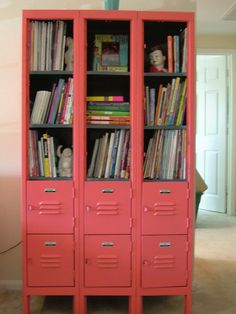 an orange bookcase with many books on it and some drawers in front of it