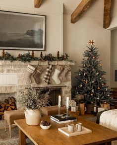 a living room filled with furniture and a fire place next to a christmas tree in front of a fireplace