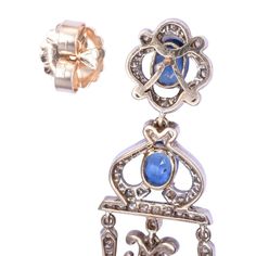 This is part of Chairish’s Fine Jewelry assortment.  Vintage 9.71 CTW sapphire & diamond girandole dangle earrings. These Victorian style vintage earrings are crafted in 18 karat yellow gold topped with silver. They feature 9.71 CTW of oval sapphires that are very well matched, eye clean, and have slight color zoning. These earrings are accented with 246 full cut diamonds at 2.00 carats total weight. The diamonds have VS1-2 clarity, with a few SI2, and have K-L-M light brown color. These earring Antique Pierced Diamond Jewelry, Victorian Sapphire Jewelry In Gold, Victorian Gold Sapphire Jewelry, Classic Yellow Gold Chandelier Earrings, Formal Rose Cut Diamond Chandelier Earrings, Formal Chandelier Earrings With Rose Cut Diamonds, Oval Sapphire Earrings With 17 Jewels, Classic Chandelier Dangle Earrings With 17 Jewels, Gold Chandelier Earrings With 17 Diamonds