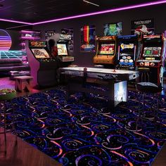 a room filled with arcade machines and neon lights