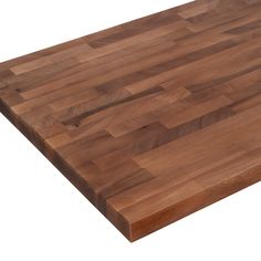 a large wooden cutting board sitting on top of a white surface with no one around it