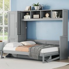 a bedroom with blue walls and a gray bed in front of a grey bookcase