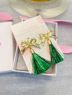 Beautiful gold ribbon earrings with a green tinsel tassel measuring approximately 2.5-3". These are great for St. Patrick's jewelry, gifts for her, preppy jewelry, classy jewelry! Giftbox included. Green Tassel Earrings For Party, Elegant Gold Earrings For The Holiday Season, Elegant Gold Earrings For Holiday, Elegant Green Earrings For Christmas, Green Jewelry For New Year Party, Green Jewelry For New Year's Party, Elegant Green Jewelry With Tassels, Elegant Green Tassel Jewelry, Elegant Green Holiday Earrings