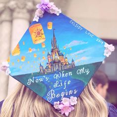 a woman wearing a graduation cap that says now's when my life begins,