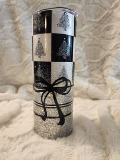 a black and white can with a bow on it