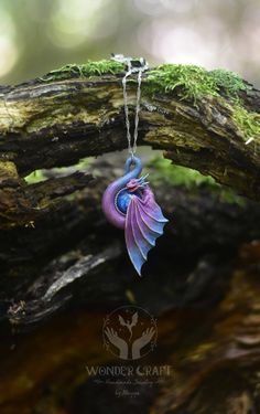 🏰Embark on a journey into the enchanted forest with this dragon necklace in purple and blue tones! This beautiful dragon pendant will serve you not just as an accessory, but as a wise guardian and spirit companion! 🔮Purple and blue dragons are often regarded as guardians of dreams and imagination. They are beings that watch over the ethereal realm, protecting dreamers and guiding their subconscious adventures. 💖The pendant hangs delicately from a chain, allowing the small dragon to rest gracefully against your chest, always close to your heart. ✨Handmade from high-quality polymer clay. The cabochon is made from premium resin. This necklace is designed to complement a variety of styles, it's a conversation starter, a symbol of fantasy and a testament to your love for all things magical! Spirit Companion, Ethereal Realm, Blue Dragons, Small Dragon, Aesthetic Necklace, Fairy Cosplay, Dragon Princess, Fantasy Style, Larp Costume