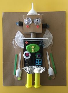 a paper doll made to look like a robot with utensils and spoons