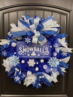 a blue and white wreath with snowballs on it