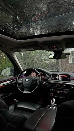 the interior of a car with black leather seats and steering wheel, dashboard lights, dash board and radio