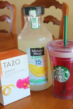 a cup of tea next to a box of orange juice and a bottle of tazo