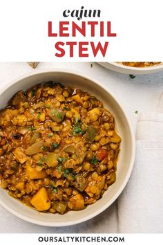 a white bowl filled with lentil stew next to another bowl full of beans and vegetables