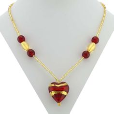 Every woman loves to own unique handcrafted jewelry. This Murano necklace in rich gold and red palette is every woman's dream, rich and beautiful like Venice itself. The authentic Murano necklace features an exquisite 24K gold-layered red heart pendant suspended from an elegant gold-lined beaded necklace accented with gorgeous 24K gold foil-lined Murano glass beads. Enjoy this unique Murano Necklace and the aura of Venetian romance and elegance that it projects. The heart measures 1 inch in heig Elegant Gold Beaded Necklace With Heart Beads, Elegant Gold Beaded Necklaces For Valentine's Day, Gold Necklaces With Heart Beads For Jewelry Making, Gold Heart Beads Pendant Necklace, Gold Pendant Necklace With Heart Beads, Elegant Red Heart Pendant Necklace, Red Beaded Necklace With Heart Pendant For Gifting, Gold Heart Beads Necklace For Gift, Gold Necklaces With Heart Beads For Gift