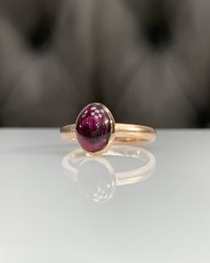 Natural Rhodolite Garnet Ring * Dainty Cabachon Ring * Genuine Garnet & 14K Solid Gold * Best Gift for Her/Him * Handmade Ring ◎ Details ◎ ○ Gemstone Details .Natural RHODOLITE GARNET Oval Cut 9X7 mm approx. 2.11 ct ○ Gold Details 14K Solid Gold Width of Band : 2.50 mm Weight of Ring : approx 3.80 gr Made to Order HANDMADE ITEM ○ Upgrade to Solid 18K Gold, please click the link below: https://www.etsy.com/listing/962826004 For more CABACHON BEZEL rings : http://etsy.me/37fvI60 All of our jew Formal 14k Gold Sapphire Ring With Oval Cabochon, Classic Yellow Gold Sapphire Ring Oval Cabochon, Yellow Gold Tourmaline Cabochon Ring, Luxury 14k Gold Oval Sapphire Ring, Classic Yellow Gold Sapphire Ring With Cabochon, Luxury Hallmarked Oval Cabochon Ruby Ring, Luxury Tourmaline Jewelry In Oval Cabochon Shape, Classic Oval Cabochon Sapphire Ring With Bezel Setting, Formal 14k Gold Oval Cabochon Dome Ring