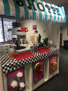 an office decorated with checkered counter tops and decorations