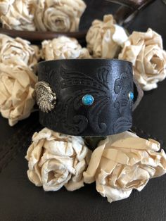 "🔸🔸orders are delayed by a few days this week. Thank you for your patience Country leather bracelet cuff, western jewelry Distressed black embossed genuine leather 1 1/2\" strap has been adorned with an antiqued silver wing attached to the leather with two textured antiqued silver rivets. Four turquoise rivets line the cuff. One antiqued silver snap has been placed to fit up to a 6 1/2\" wrist. I can add another snap for a smaller or larger wrist size but you need to convo me before purchasing Cowgirl Bracelets, Cowgirl Gifts, Chunky Bracelet, Santa Clarita, Silver Wings, Chunky Bracelets, Western Leather, Leather Cuffs Bracelet, Bracelet Cuff