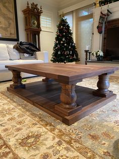 a living room with a coffee table and christmas tree in the backgroung