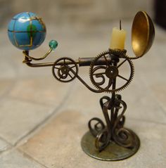 a candle holder with a globe on it