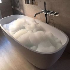 a bathtub filled with foam in a bathroom