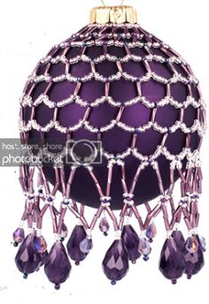 a purple christmas ornament hanging from a chain