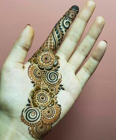 the hand is decorated with henna designs on it