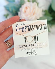 someone is holding up a card with a ring on it that says, happy birthday to you friends for life enjoy your special day