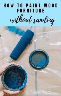 a person holding a paint can with the words how to paint wood furniture without sanding