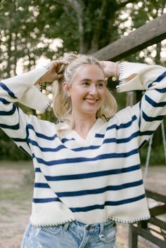 Step up your sweater game this Fall with our Navy & Cream Stripe Collared Sweater! This cream sweater features navy stripes and a classic collared design. The flowy knit material is both comfortable and stretchy, making it the perfect addition to your wardrobe. Stay stylish and cozy all season long with this must-have piece! runs true to size with stretch model, Lauren is wearing a size medium Fall V-neck Top With Striped Collar, Striped V-neck Sweater For Fall, Striped Navy Sweater, Cream And Navy Steiped Sweater, Winter Striped Long Sleeve V-neck Sweater, Collared Sweater, Boutique Trends, Cream Sweater, Collar Sweater