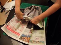 a person is doing something on top of newspaper