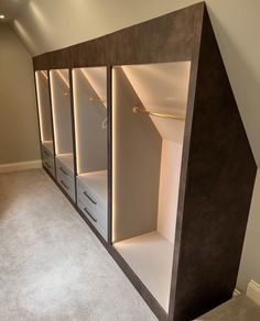 an empty room with some shelves and drawers in the corner, along with carpeted flooring