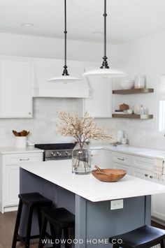 A kitchen island with seating not only adds extra dining options but also maximizes space. In this remodel, we had smaller custom cabinets built to gain extra inches while keeping full-depth end panels. This created the perfect spot for stools to tuck in, enhancing both style and function. Explore how our design blends practicality and aesthetic in this kitchen remodel for a space that's both inviting and efficient! Visit Wildwood Home Co at wildwoodhomecompany.com. Farmhouse Island Kitchen, Contrasting Kitchen Island, Zionsville Indiana, Beautiful White Kitchens, Top Kitchen Trends, Two Tone Kitchen Cabinets, Small Kitchen Island, Timeless Kitchen, Kitchen Cabinet Styles