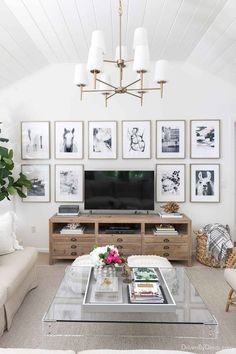 a living room with pictures on the wall and a television in the centerpieces