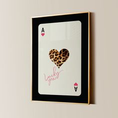 a framed ace playing card with an animal print heart