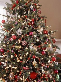 a decorated christmas tree with red and gold ornaments