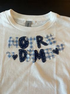 a t - shirt with the words more dmrs on it, in blue and white plaid