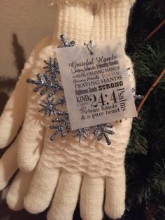 a pair of white gloves hanging from a christmas tree with a price tag on it