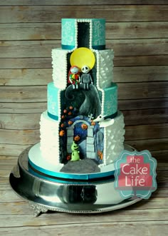 a three tiered cake decorated with cartoon characters