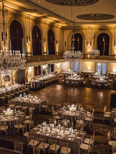 a large ballroom with chandeliers and tables