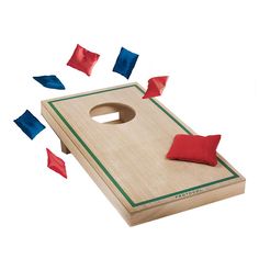 a wooden board with red, white and blue pieces flying around it