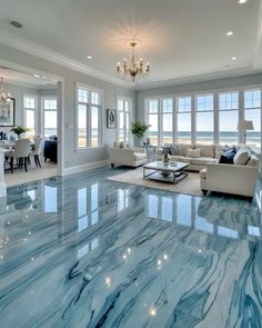 a living room filled with furniture and large windows