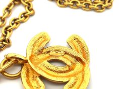 Specifications:Designer: CHANELTotal Weight: 140 GramsPendant CC Measurements: ~2.25" x 1.9"Chain Length: ~30" with bailStamped: "CHANEL "Made in France"Condition: PreownedGold Plated Metal Pendant Jewelry With Gold-tone Logo Plaque, Metal Pendant Necklace With Gold-tone Logo Plaque, Vintage Jewelry With Gold-tone Logo Plaque, Vintage Gold Necklace With Gold-tone Logo Plaque, Gold-tone Logo Plaque Pendant Necklace, Vintage Gold-tone Necklace With Logo Charm, Vintage Yellow Gold Jewelry With Logo Charm, Vintage Necklace With Logo Charm For Formal Occasions, Designer Gold Hallmarked Necklace