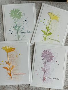 four cards with flowers on them sitting next to each other and the words happy birthday