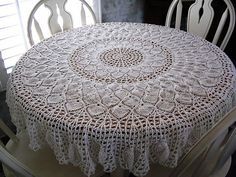 a white table with a doily on top of it