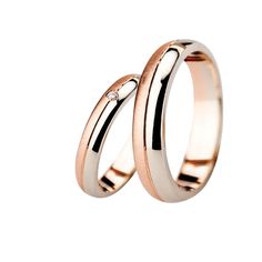 two gold wedding rings with diamonds on each side, set in white and rose gold