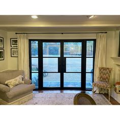 a living room filled with furniture and a sliding glass door