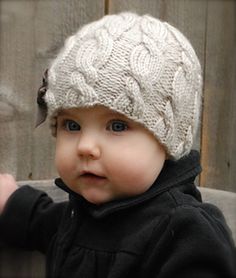 a small child wearing a knitted hat