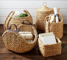 woven baskets with handles are arranged on a wooden floor