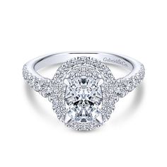 an oval cut diamond engagement ring with double halos