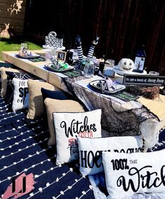 the table is covered with pillows and other decorative items for halloween party guests to sit on