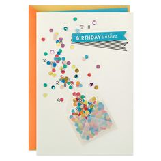 a birthday card with confetti and streamers on the front, and an envelope that says happy birthday wishes