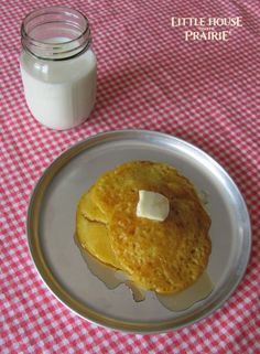 a pancake on a plate next to a jar of milk and a glass of milk